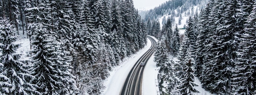 car driving on asphalt road through the winter