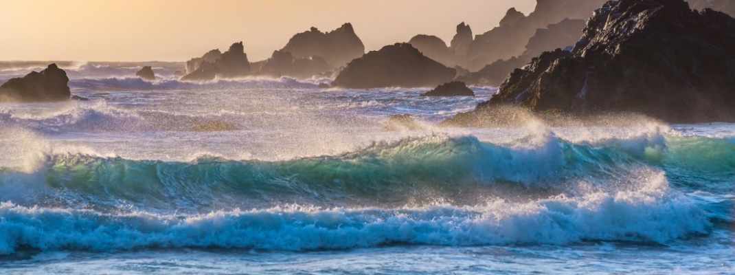Breakers roll in at sunset on Pfeiffer Beach in Big Sur, California.