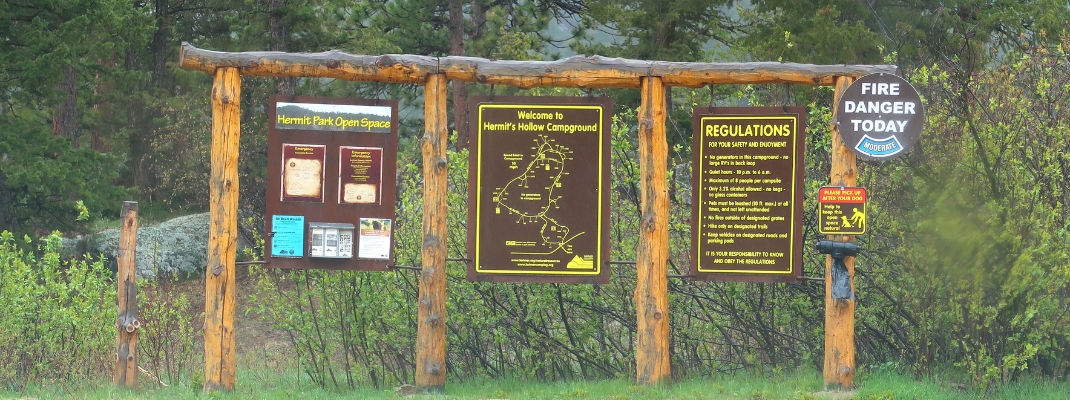 Entrance signs to Hermit's Hollow campground at Hermit Park