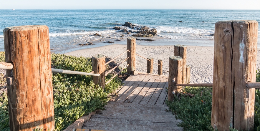 Stairs leading down to the beach and Pacific ocean at Carpinteria State Beach, California.