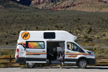 Family sitting in Hi5 Campervan on road