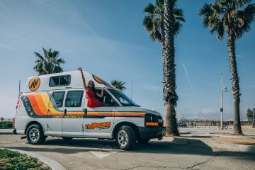 HiTop campervan parked next to beach