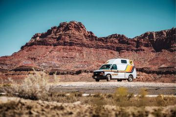 HiTop Campervan parked next to road in desert